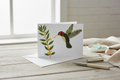 Greeting card with a decorative design of a bird and plants on a white background