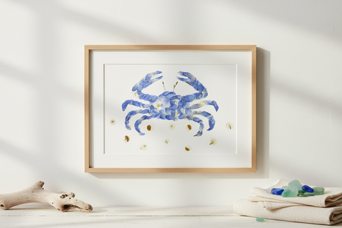 Framed artwork of a blue crab with gold accents on a white background