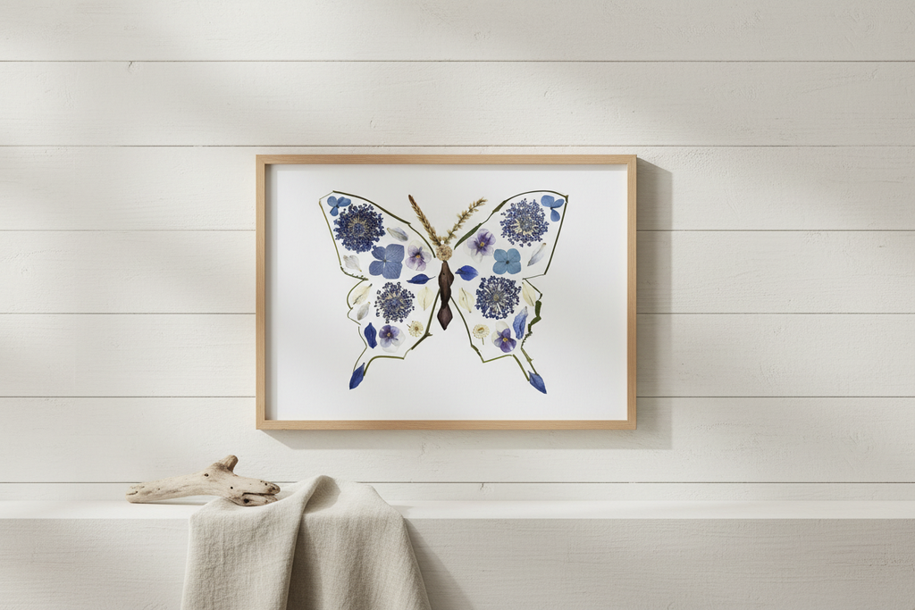 Butterfly-shaped artwork made of pressed flowers with a gold frame.