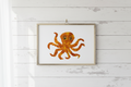 Artistic depiction of an octopus made from pressed flowers on a white background