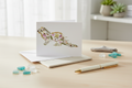 Greeting card with a decorative otter design on a white background