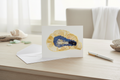 Greeting card with a pressed flower oyster abstract design on a white background
