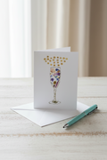 Greeting card with a floral champagne glass design on a white background