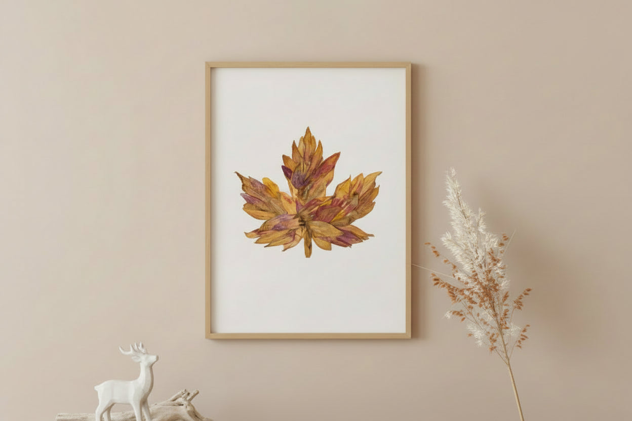 A single dried autumn maple leaf with mottled golden yellow, orange, and reddish-brown tones, isolated on a plain white background.