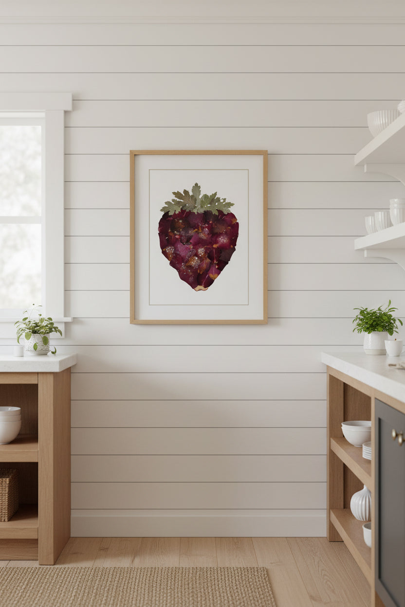 A strawberry made from dark burgundy and purple dried flower petals with a green leafy top, photographed on a plain white background.