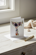 Greeting card with pressed flower whales tail  design on a white background