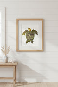 A pressed flower turtle crafted with green leaves for the shell and limbs, and a yellow rose petal head, shown on a plain white background.